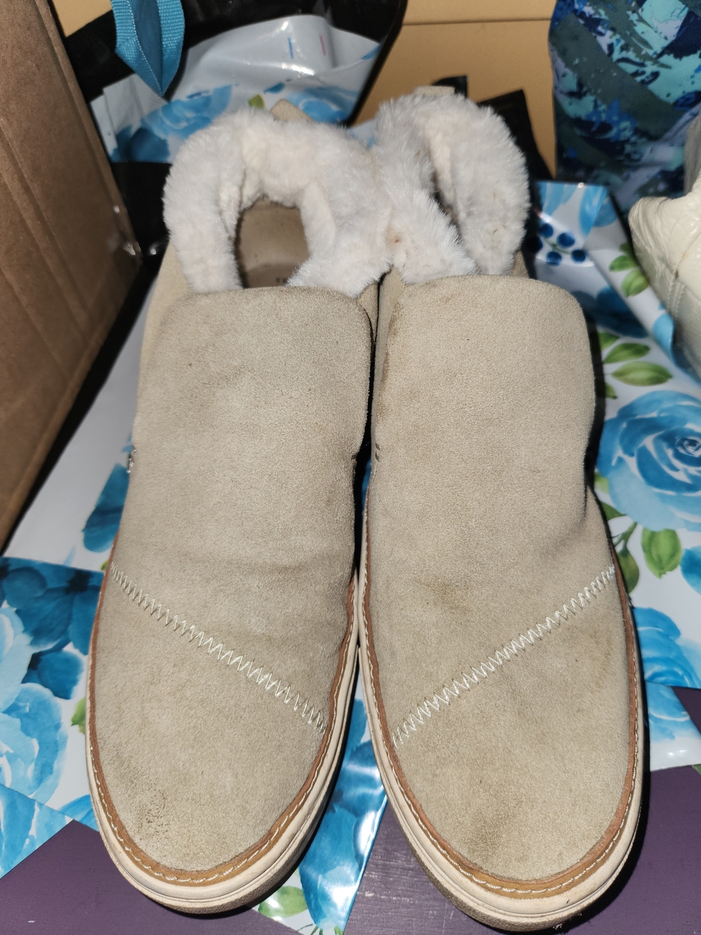TOMS Paxton suede slip-on shoes featuring a cozy white faux-fur lining
